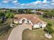 Single-story home with tile roof, driveway, and landscaped lawn in a golf course community at 2337 Platinum Dr, Sun City Center, FL 33573