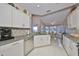 Modern kitchen with granite countertops and white cabinets at 2337 Platinum Dr, Sun City Center, FL 33573