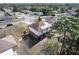 Aerial view of the house featuring a solar panel roof, backyard patio, and mature trees at 2359 Gimlet Ave, Spring Hill, FL 34608