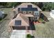 Aerial view of the two story home showcasing the roof and solar panels at 2359 Gimlet Ave, Spring Hill, FL 34608