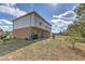Large backyard with a charming patio area and sliding door, providing easy access to the outdoor space at 2359 Gimlet Ave, Spring Hill, FL 34608