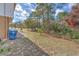 A large, partially shaded backyard complete with a patio and garbage bins, ideal for outdoor activities at 2359 Gimlet Ave, Spring Hill, FL 34608