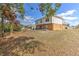 Expansive backyard with a combination of grassy space and a patio ideal for outdoor entertaining at 2359 Gimlet Ave, Spring Hill, FL 34608