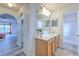 Bathroom has white walls, wood cabinets, and gray flooring at 2359 Gimlet Ave, Spring Hill, FL 34608