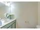 Cozy bathroom featuring a vanity with a sleek countertop and decorative floral arrangement at 2359 Gimlet Ave, Spring Hill, FL 34608