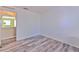 Bedroom displaying modern flooring and a view of the adjacent hallway at 2359 Gimlet Ave, Spring Hill, FL 34608