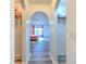 Arched hallway overlooks bedroom with hardwood floors and bed at 2359 Gimlet Ave, Spring Hill, FL 34608