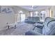 Open living room with a ceiling fan, a plush rug, and three reclining chairs at 2359 Gimlet Ave, Spring Hill, FL 34608