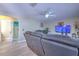 Living room featuring a plush reclining sofa, ceiling fan, and arched doorways at 2359 Gimlet Ave, Spring Hill, FL 34608