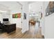 Bright hallway with wood-look floors, leading to various rooms at 2903 Satilla Loop, Odessa, FL 33556