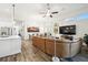 Open concept living room and kitchen with hardwood floors and leather sectional sofa at 2903 Satilla Loop, Odessa, FL 33556