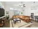 Relaxing living room featuring a brown leather sectional sofa and large TV at 2903 Satilla Loop, Odessa, FL 33556