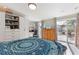 Main bedroom with king bed, built-in shelving, and sliding glass doors at 3168 Meadow Lake Ave, Largo, FL 33771