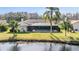 Inviting backyard with screened-in pool overlooking a tranquil lake at 3360 Hickorywood Way, Tarpon Springs, FL 34688