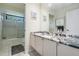 Bathroom featuring a granite countertop, white cabinets, and a tub-shower combo at 3360 Hickorywood Way, Tarpon Springs, FL 34688