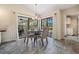 Bright dining area features backyard views, modern chandelier and neutral tones at 3360 Hickorywood Way, Tarpon Springs, FL 34688