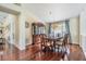 Dining room with hardwood floors, chandelier, china cabinet, and seating for six at 3360 Hickorywood Way, Tarpon Springs, FL 34688