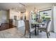 Open-concept dining area with stylish furnishings and easy access to kitchen and outdoor spaces at 3360 Hickorywood Way, Tarpon Springs, FL 34688