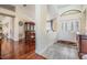 Foyer features tile floors and view into dining room with hardwood floors at 3360 Hickorywood Way, Tarpon Springs, FL 34688