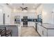 Bright kitchen featuring stainless steel appliances, granite countertops, and white cabinetry at 3360 Hickorywood Way, Tarpon Springs, FL 34688