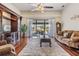 Spacious living room with hardwood floors and a sliding glass door to the backyard at 3360 Hickorywood Way, Tarpon Springs, FL 34688
