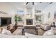 Living room with hardwood floors, fireplace, and large windows at 3360 Hickorywood Way, Tarpon Springs, FL 34688