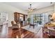 A large and open living room with backyard views and hardwood flooring at 3360 Hickorywood Way, Tarpon Springs, FL 34688