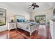 This is the main bedroom with light walls, ceiling fan, and access to the outdoors at 3360 Hickorywood Way, Tarpon Springs, FL 34688