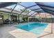 Spacious screened-in pool area with ample seating, perfect for entertaining and relaxation at 3360 Hickorywood Way, Tarpon Springs, FL 34688