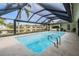 Sparkling screened-in pool offering a refreshing escape with scenic waterfront views at 3360 Hickorywood Way, Tarpon Springs, FL 34688