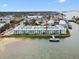 Aerial view of waterfront building with private dock at 464 N Paula Dr # 322, Dunedin, FL 34698