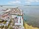 Aerial view of waterfront condo building with pool and parking at 464 N Paula Dr # 322, Dunedin, FL 34698