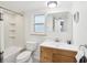 Updated bathroom with a tub, toilet, and wood vanity at 464 N Paula Dr # 322, Dunedin, FL 34698