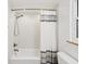 Clean bathroom with shower/tub combo, updated vanity, and window at 464 N Paula Dr # 322, Dunedin, FL 34698