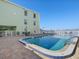 Refreshing community pool with patio furniture at 464 N Paula Dr # 322, Dunedin, FL 34698