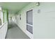 Clean hallway with light walls and an exit sign at 464 N Paula Dr # 322, Dunedin, FL 34698