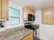 Kitchen with granite countertops and stainless steel appliances at 464 N Paula Dr # 322, Dunedin, FL 34698
