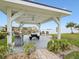 Covered patio with grill, picnic table, and waterfront view at 464 N Paula Dr # 322, Dunedin, FL 34698