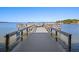 Private wooden dock extending over calm water at 464 N Paula Dr # 322, Dunedin, FL 34698
