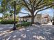 Ice cream shop and other businesses along a brick-paved street with trees at 464 N Paula Dr # 322, Dunedin, FL 34698