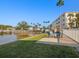 Seating area on waterfront patio with kayaks and grill at 464 N Paula Dr # 322, Dunedin, FL 34698