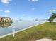 Stunning waterfront view with lush green lawn at 464 N Paula Dr # 322, Dunedin, FL 34698