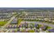 Bird's-eye view of a house in a large residential area near a lake at 4919 Pamplona Ct., Wimauma, FL 33598