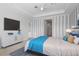 Bright bedroom with a large bed and en-suite bathroom at 4919 Pamplona Ct., Wimauma, FL 33598