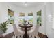 Bright breakfast nook with a table and four chairs, overlooking a scenic view at 4919 Pamplona Ct., Wimauma, FL 33598