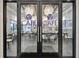 Cafe Del Sol entrance with glass doors and modern lighting at 4919 Pamplona Ct., Wimauma, FL 33598