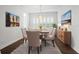 Formal dining room with a wooden table, six chairs, and a sideboard at 4919 Pamplona Ct., Wimauma, FL 33598