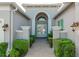 Elegant entryway with double doors, arched window, and brick pathway at 4919 Pamplona Ct., Wimauma, FL 33598