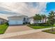 Two-story house with gray exterior, two-car garage, and landscaped front yard at 4919 Pamplona Ct., Wimauma, FL 33598