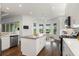 Modern kitchen with white cabinets, stainless steel appliances, and an island with seating at 4919 Pamplona Ct., Wimauma, FL 33598